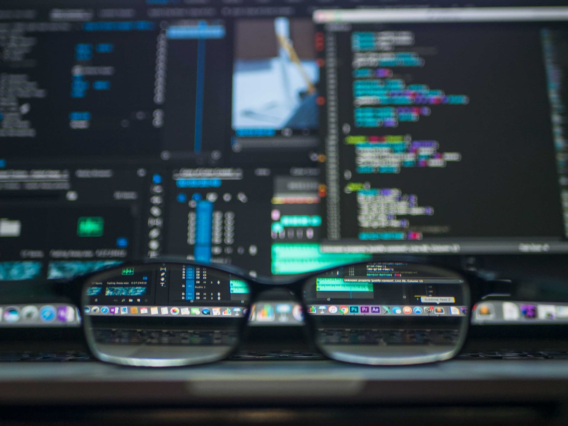 Glasses positioned to reveal computer code in focus behind