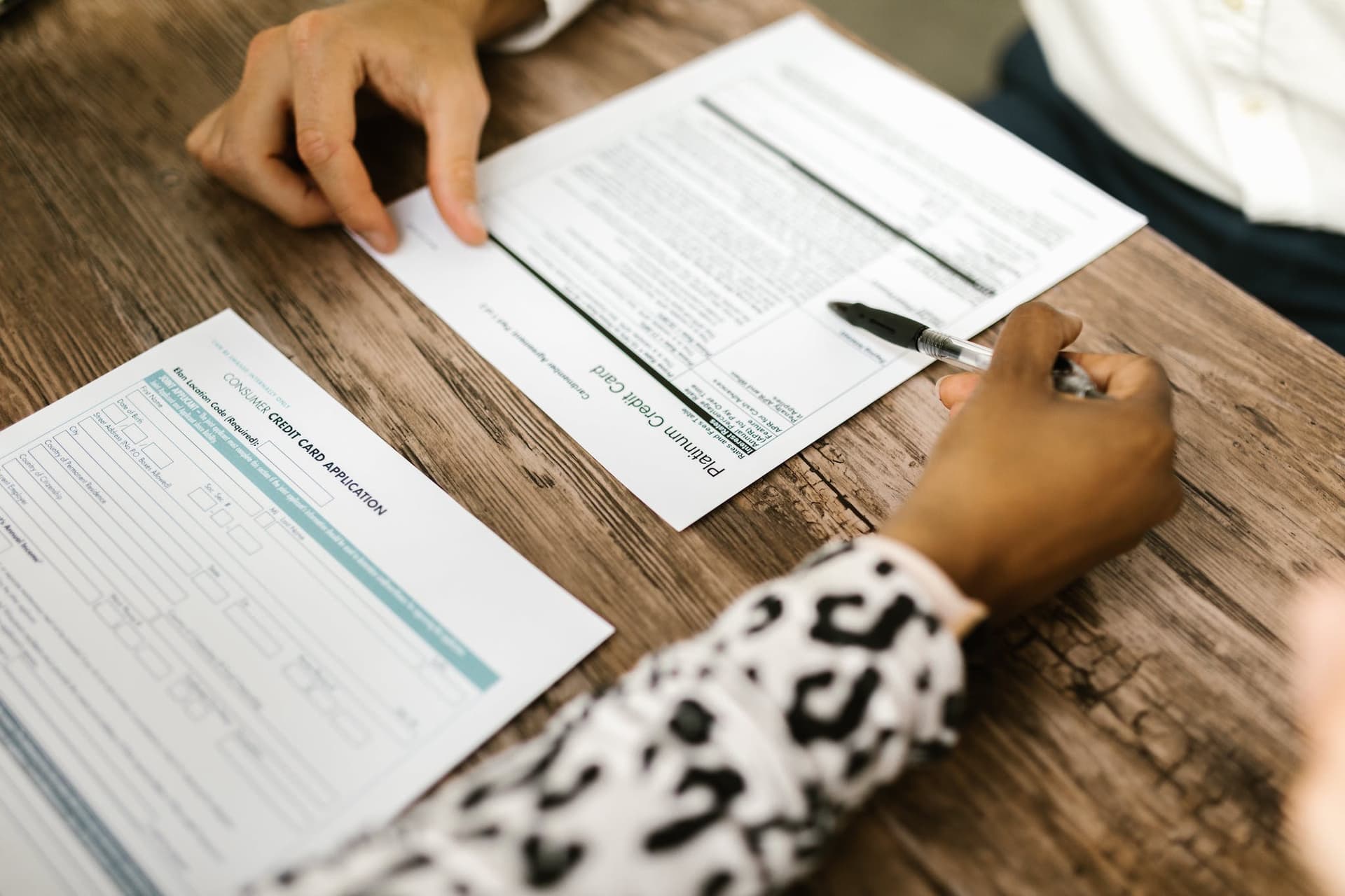 Two unseen people filling out an application